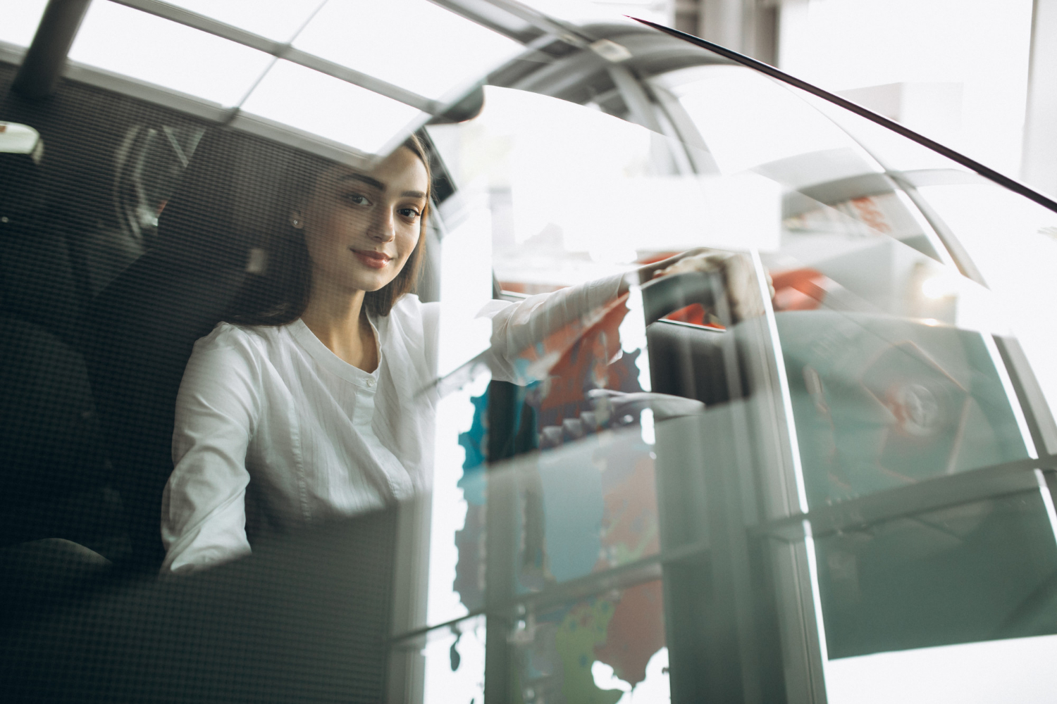 young-woman-sitting-car-car-showroom